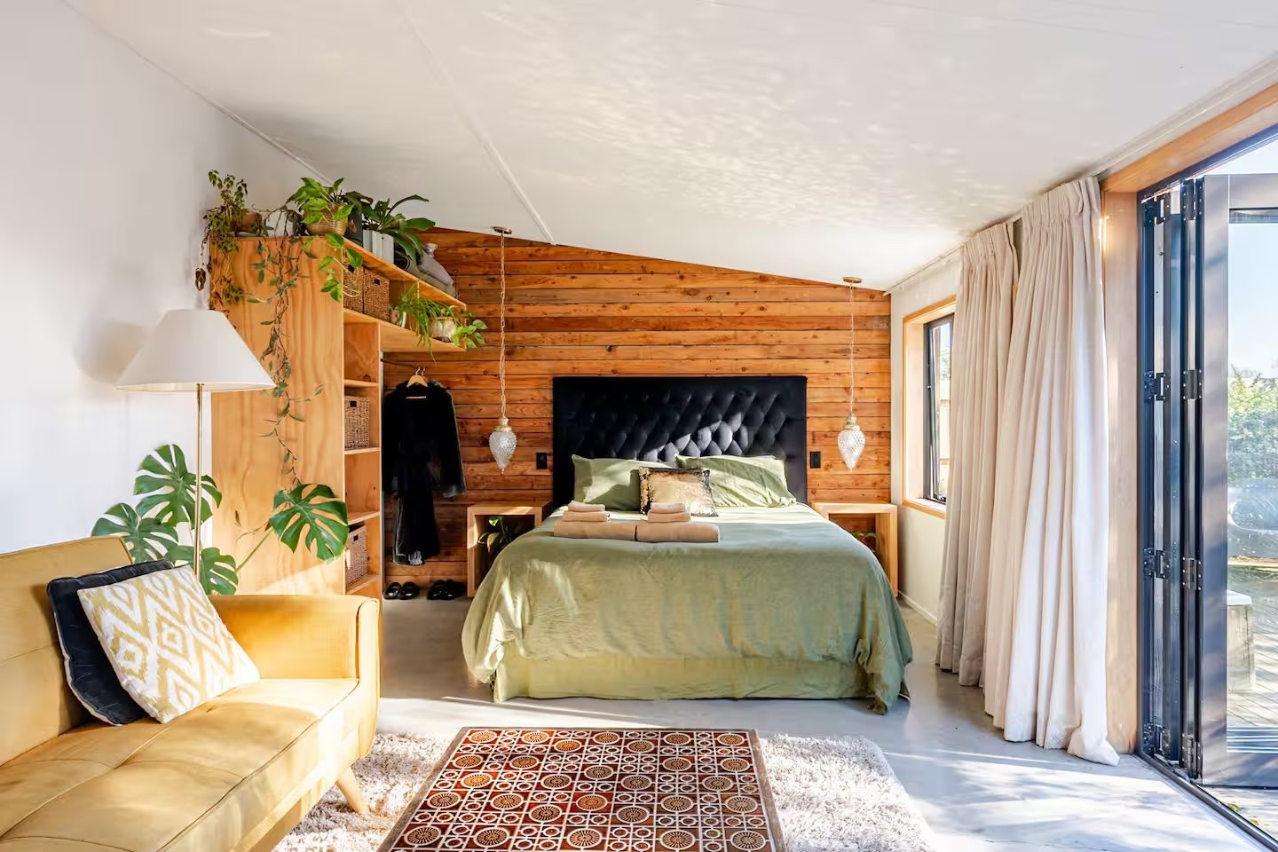 Barn 8, bedroom with cedar feature wall and tufted headboard